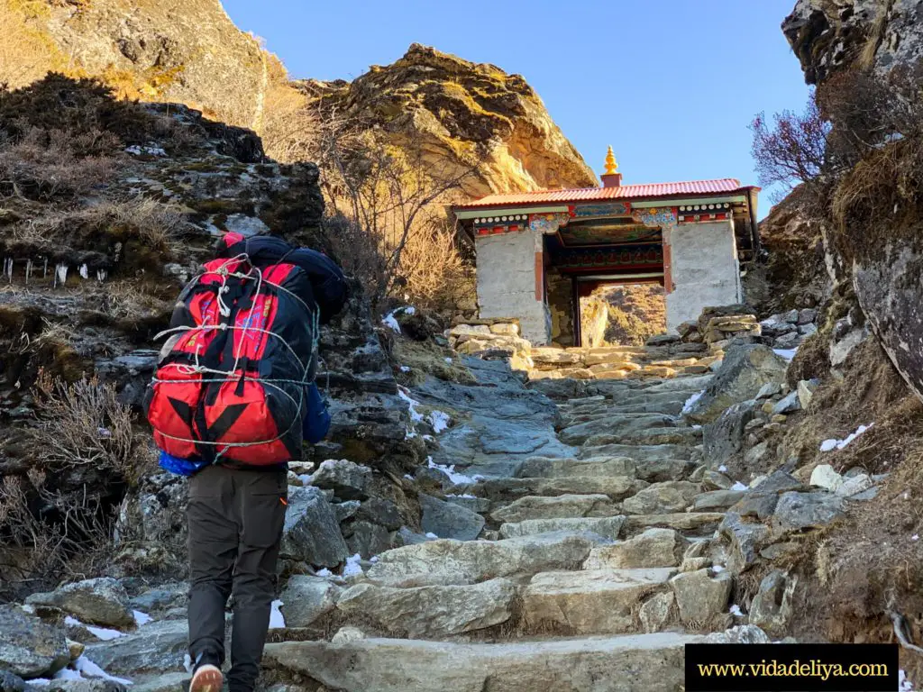 5. a local Sherpa porter carrying 30+kg bags up the Himalayan mountains along the way to the Everest Base Camp trek